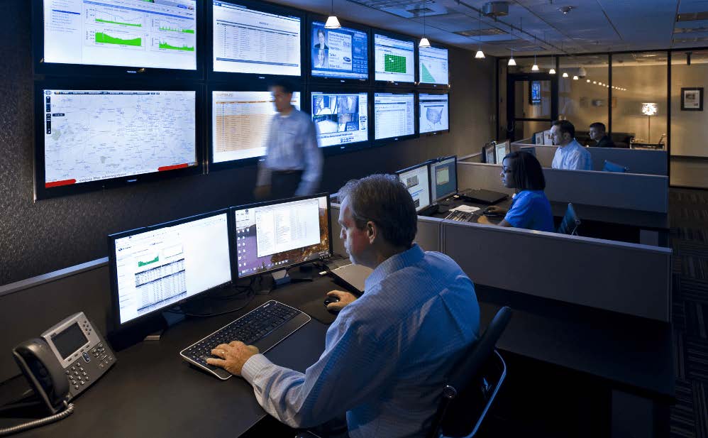 Man on his computer in control room